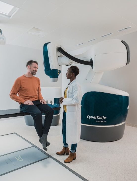 a man and a woman in a room with a large machine